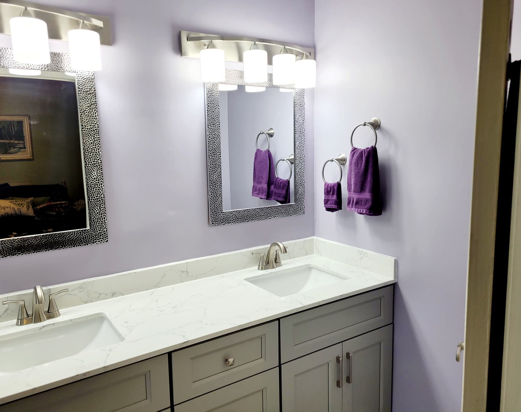 Bathroom vanity cabinetry, stone counter and matched mirrors